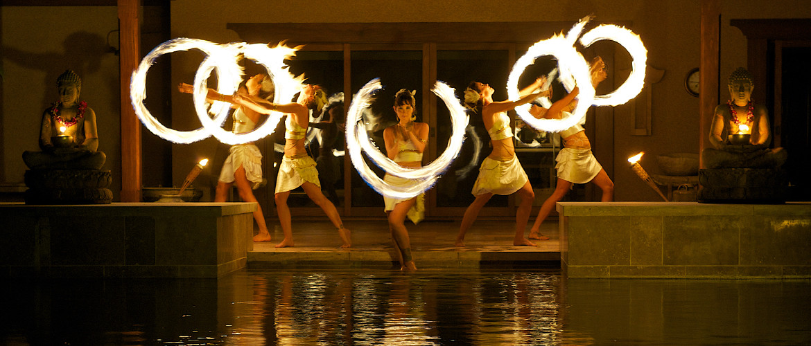 Exotic and alluring fire dancers perform a theatrical show at a Hawaii event